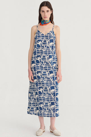 Woman wearing navy and cream patterned mini length dress. 