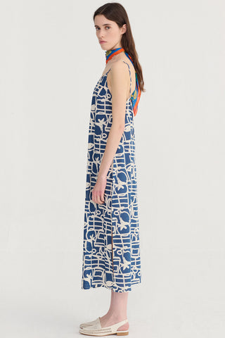 Woman wearing navy and cream patterned mini length dress. 