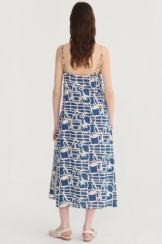 Back view of woman wearing navy and cream patterned mini length dress. 