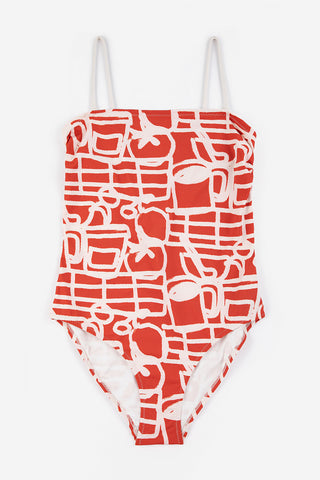 Red and cream printed one-piece swimsuit on white background. 