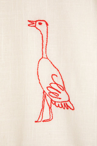 Close-up of red bird embroidery. 