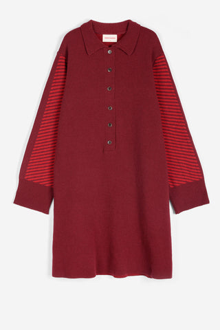 A long-sleeve knit polo dress in deep burgundy, featuring red and burgundy striped knit sleeves and a buttoned collar.