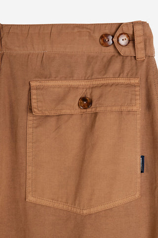 Close-up of back pocket and waistband on brown Bobo Choses pants. 