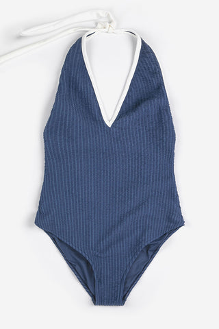Navy blue stripe one-piece swimsuit with white trim and ties. 