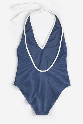 Back of navy pinstripe one-piece swimsuit with white behind the neck ties. 
