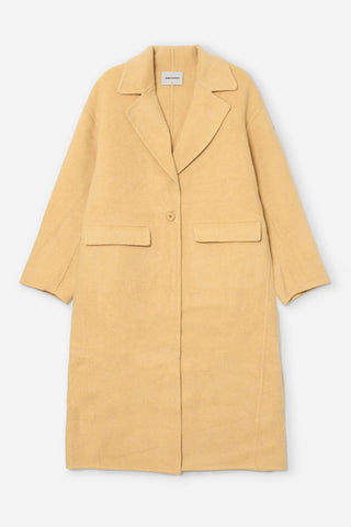 A light yellow wool-blend coat with a single button closure, notched lapels, and two front flap pockets, shown flat against a light gray background.