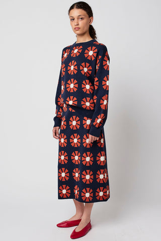 Woman wearing retro geometric floral print knit skirt and matching sweater by Bobo Choses. 