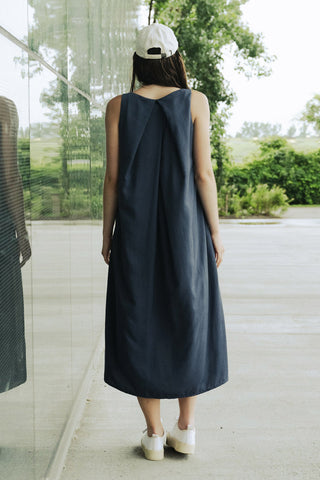 Back view of woman wearing navy tencel v-neck maxi Cassie Dress by Bodybag. 