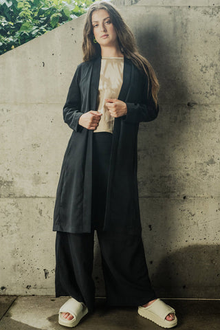 Woman wearing black OKEO-TEK certified tencel Orleans jacket by Bodybag. 