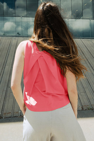 Woman wearing raspberry pink OEKO-TEK certified linen blend pleated back Pacifica tank top by Bodybag. 