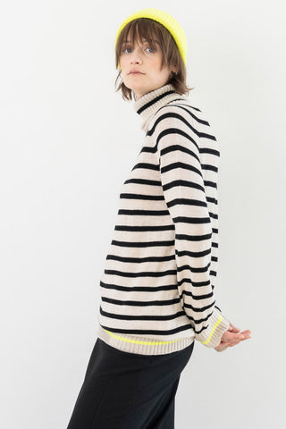 Model wearing black and white stripe Merino wool Celebration Sweater by Bodybag. 