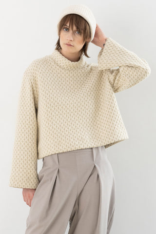 Model wearing cream coloured textured bell sleeve Waters top by Bodybag. 
