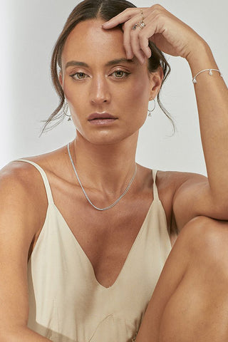 Model wearing jewellery by Camillette, including the Silver Loop necklace.