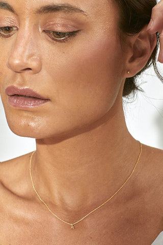 Model wearing gold Spark Necklace by Camillette. 