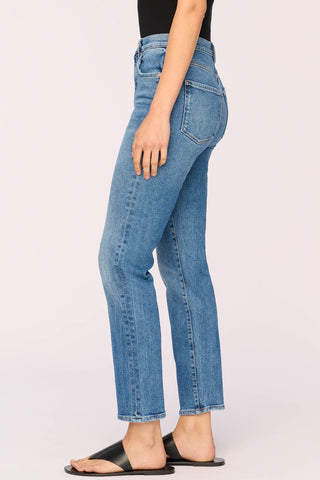 Side view of woman wearing mid-indigo Light Driggs wash ultra high rise vintage inspired cigarette cut Enora jeans by DL1961. 