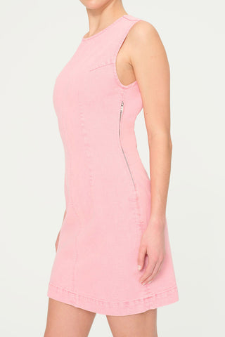 Side view of woman wearing fitted pink denim Esme dress by DL1961. 