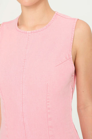 Close-up of woman wearing fitted pink denim Esme dress by DL1961. 