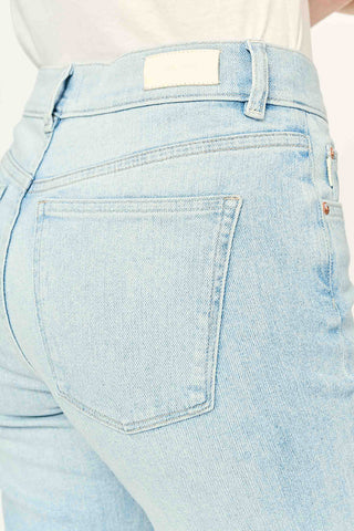 Close-up of light indigo Bali wash high rise cropped Patti jeans by DL1961. 