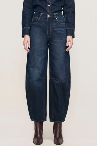 Model wearing Ventura dark wash high rise barrel leg Miro Jeans by DL1961. 