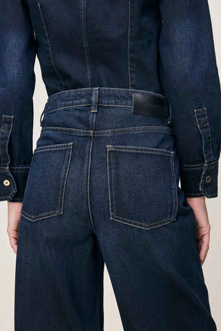 Close-up of back view of model wearing Ventura dark wash high rise barrel leg Miro Jeans by DL1961. 