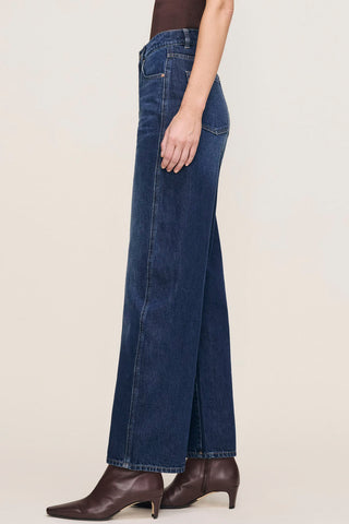 Side view of model wearing a relaxed fit barrel leg Taylor jeans by DL1961. 