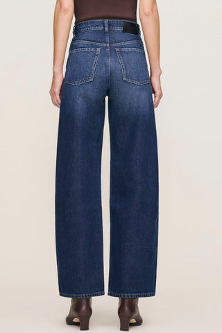 Back view of model wearing a relaxed fit barrel leg Taylor jeans by DL1961. 