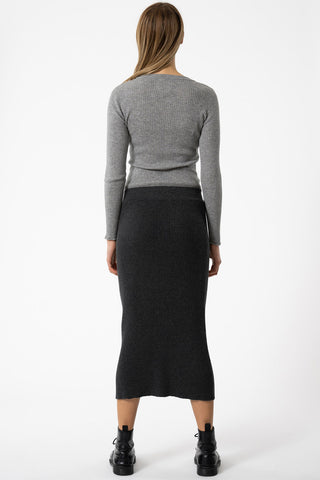 Model wearing fitted ribbed merino skirt by Dinadi. 