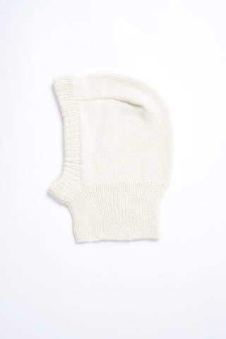 Flat lay photo on white background of ivory knit alpaca wool Balaclava by Dinadi. 