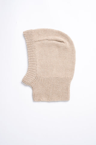 Flat lay photo on white background of sand knit alpaca wool Balaclava by Dinadi. 