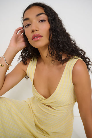 Woman wearing a yellow dress against a white background