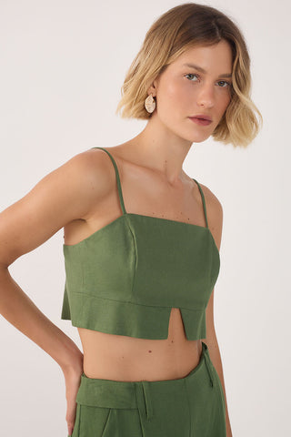 Woman wearing green cropped tank top with spaghetti shoulder straps and green matching bottoms. 