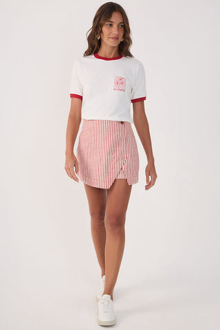 Woman wearing white t-shirt with red trim with red and white stripe asymmetrical front short. 