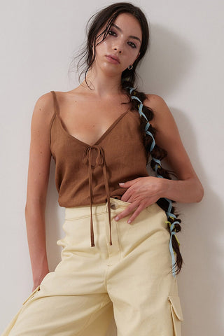 Model wearing brown linen slip tank top by Eliza Faulkner. 