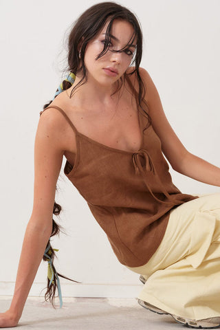 Model wearing brown linen slip tank top by Eliza Faulkner. 