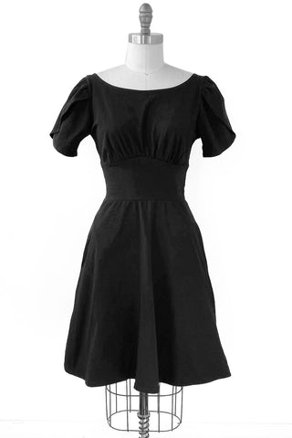 Black dress on a mannequin against a white background