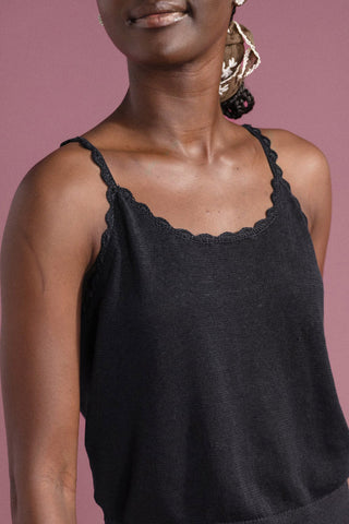 Close-up of woman wearing black linen blend scalloped neckline Clover tank top by Hansel from Basel. 