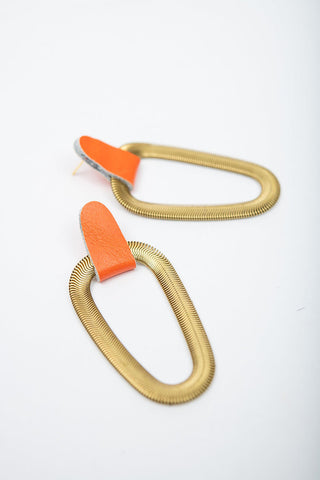Neon orange leather and brass 9e Avenue earring by Veinage. 