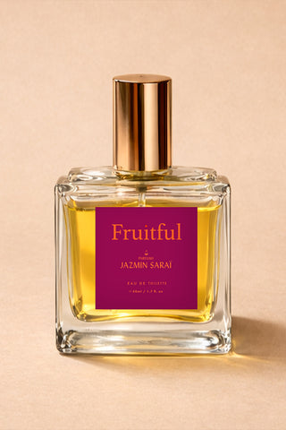 Perfume bottle labeled 'Fruitful' by Jazmin Sarai on a beige background