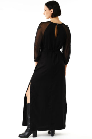 Back view of woman in front of white background wearing black full length Betana Dress by Jennifer Glasgow. 