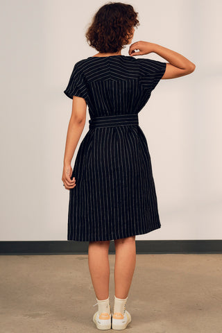 Back view of woman wearing oversized linen black and white stripe Camilla dress with Jennifer Glasgow. 