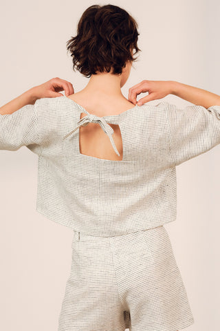Back view of woman wearing boxy linen blend grid print Cardera Top by Jennifer Glasgow. 