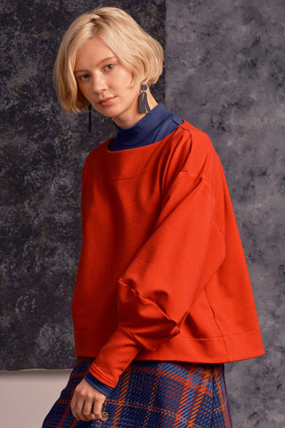 Model wearing red OEKO-TEK tencel organic cotton blend Clyde Sweater by Jennifer Glasgow. 