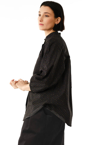 Side view of woman wearing black star print button up Dahlia shirt by Jennifer Glasgow. 
