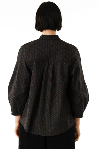 Back view of woman wearing black star print button up Dahlia shirt by Jennifer Glasgow. 