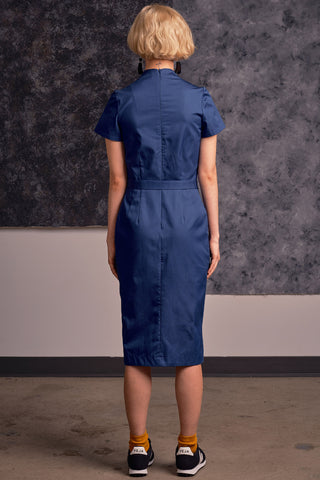 Back view of model wearing flight blue organic cotton Dahomey Dress by Jennifer Glasgow. 