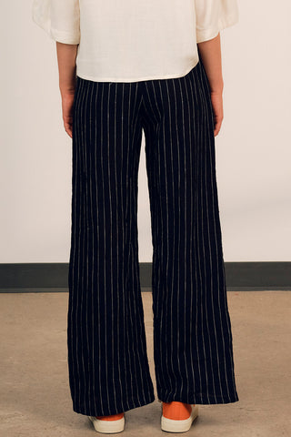 Back view of woman wearing black stripe linen Diane Pants by Jennifer Glasgow. 