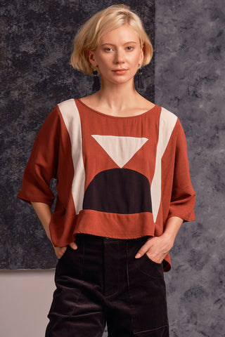 Model wearing oversized rust and black colour blocked Eris top by Jennifer Glasgow. 