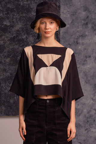 Model wearing oversized black and pink colour blocked Eris top by Jennifer Glasgow. 
