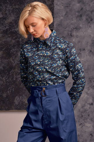Model wearing blue floral print Fianna button up shirt by Jennifer Glasgow. 