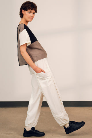 Model wearing white cotton track inspired Finnely Pants by Jennifer Glasgow. 